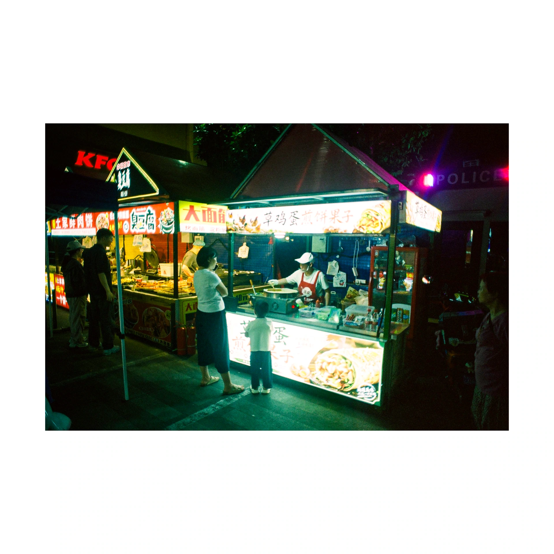 Illuminated food stall at a night market