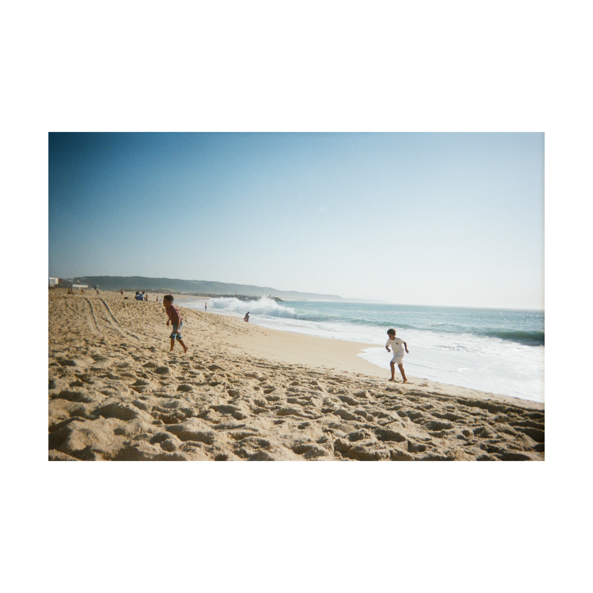 Film photograph of a beach in Portugal, with its white margins
