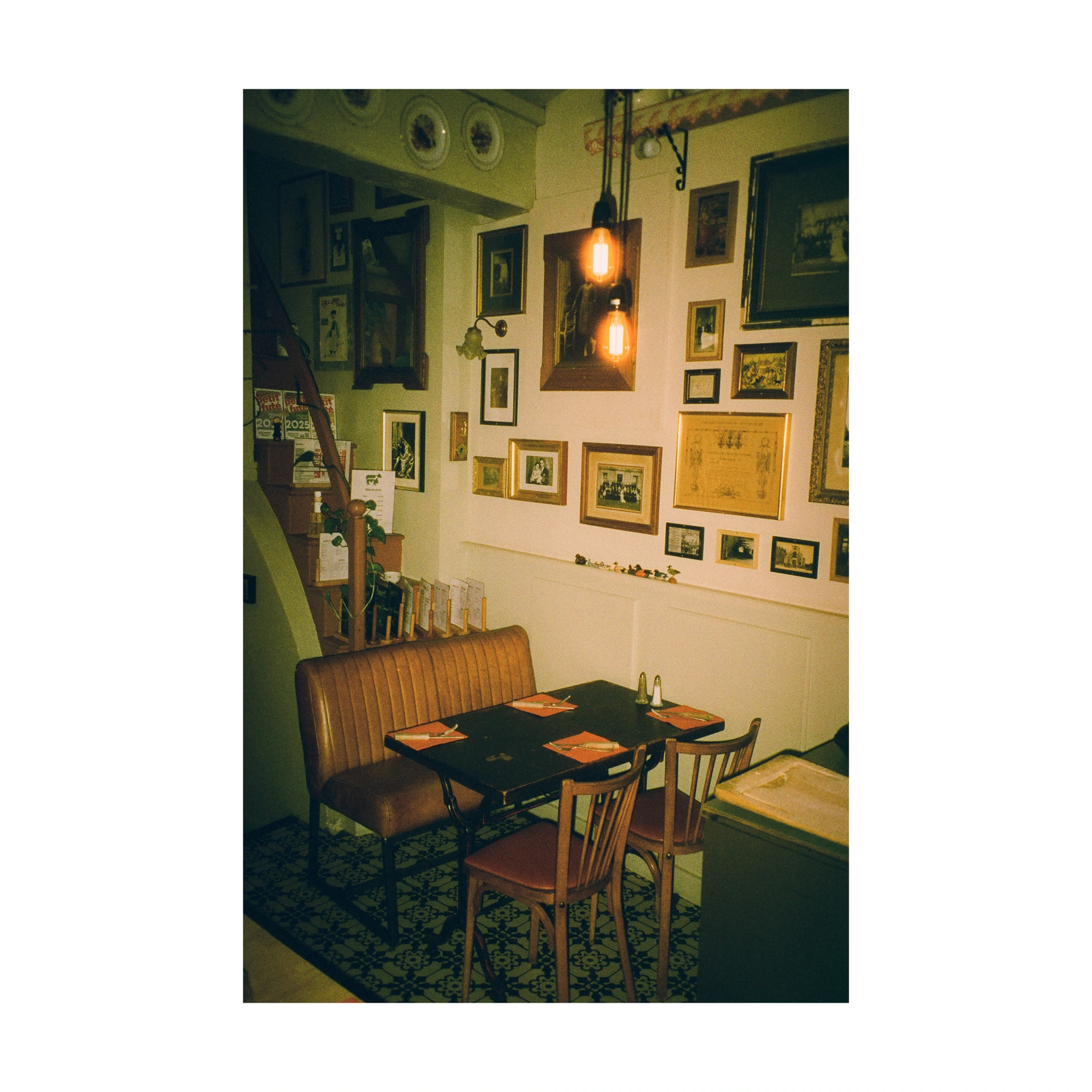 Restaurant table in an interior with picture-covered walls