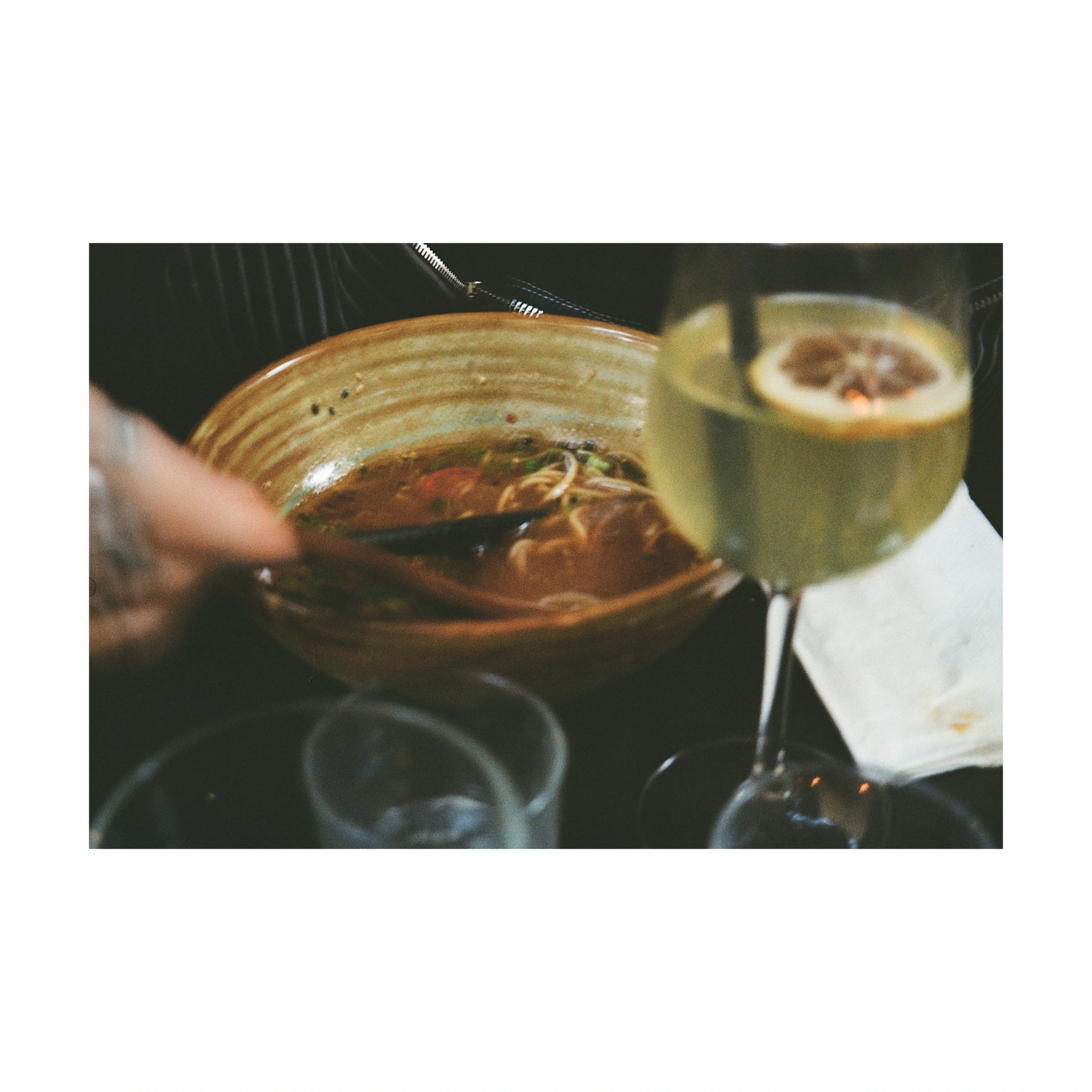 Hand, glass and plate on a restaurant table